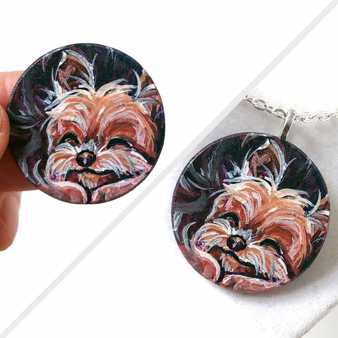 a small, smooth, wood disc, hand painted with a portrait of a sleeping Yorkshire terrier dog. available as a wood keepsake or pendant necklace.