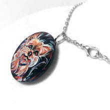 Load image into Gallery viewer, a small wood circle, hand painted with a sleeping, smiling, yorkshire terrier, available as a keepsake or pendant necklace
